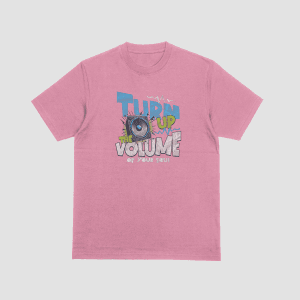 A pink t-shirt with a retro 90s-style graphic featuring a blue speaker cabinet and the text "TURN UP THE VOLUME OF YOUR SOUL" in stylized blue, green, and white lettering. Part of the Dare To Live Vibe range.